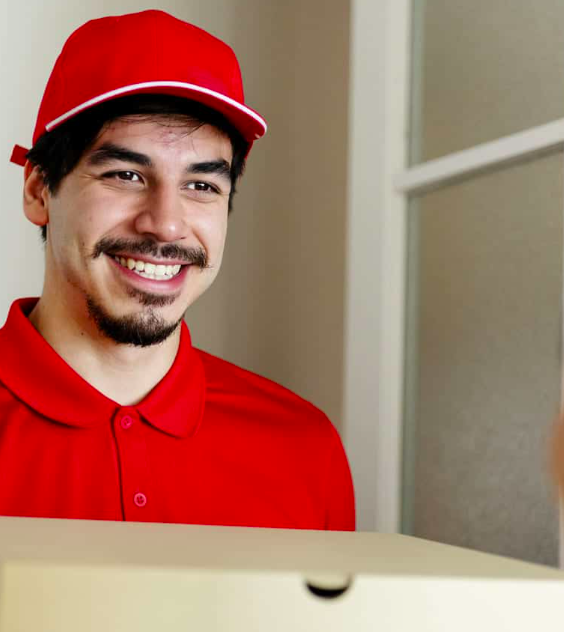 a man in a red shirt and cap smiling